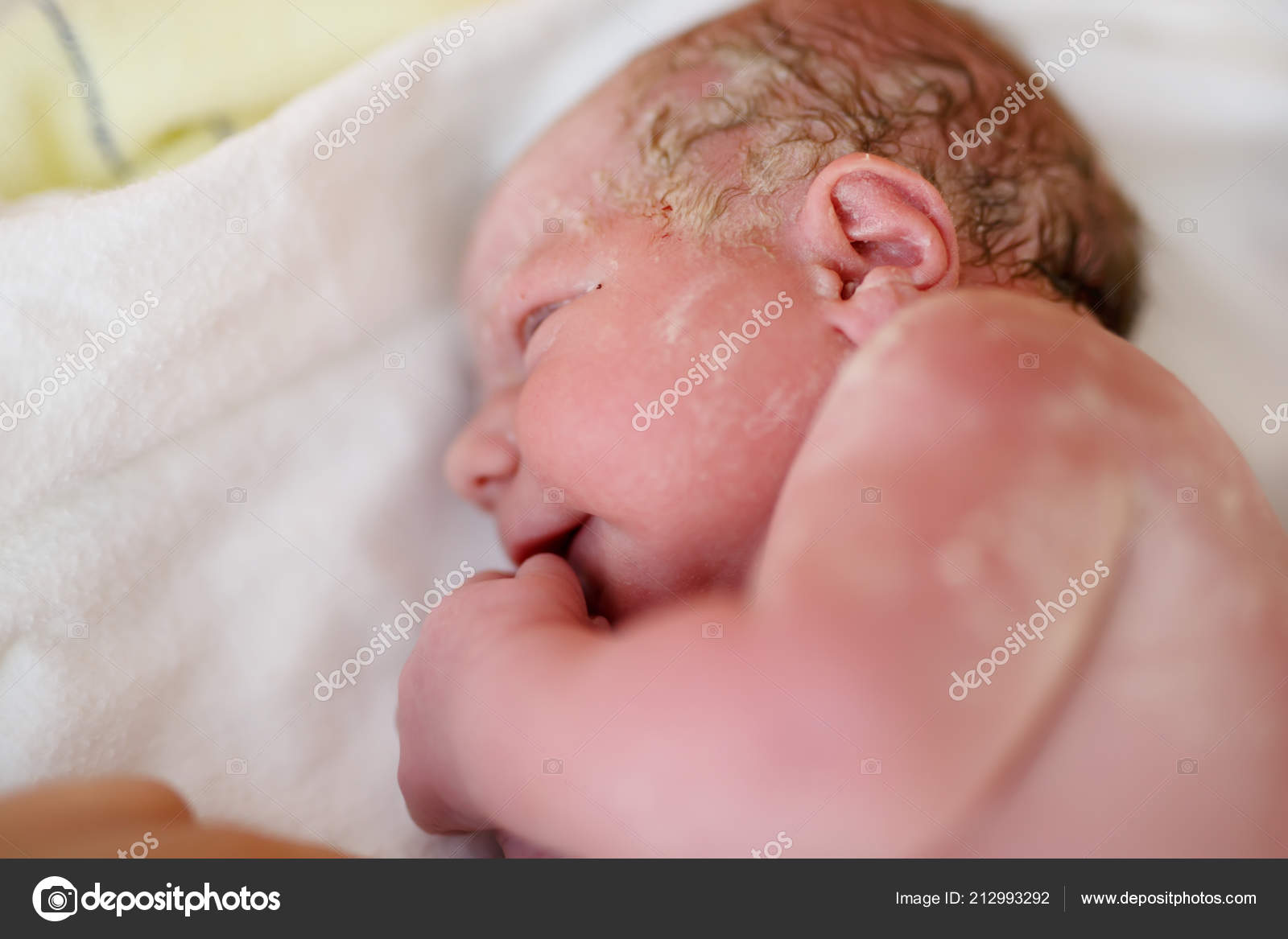 Newborn child seconds and minutes after birth. Cute tiny new born baby girl  on towel. New life, beginning, healthcare Stock Photo by ©romrodinka  212993292